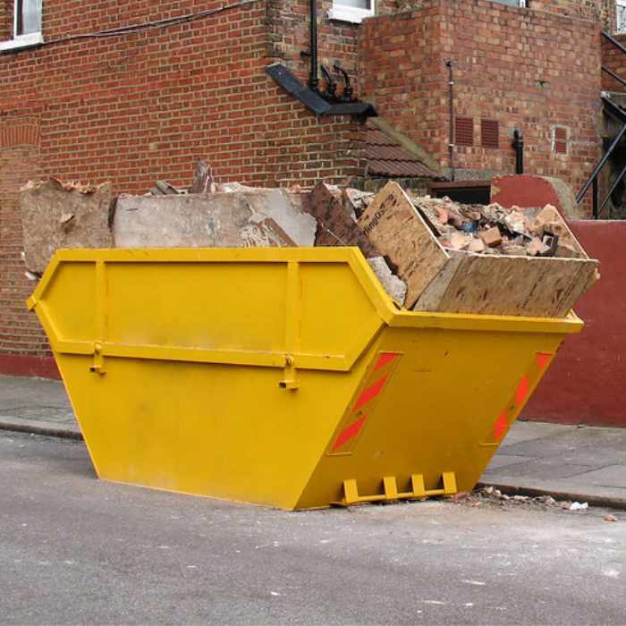A yellow skip on the side of a road in nottingham